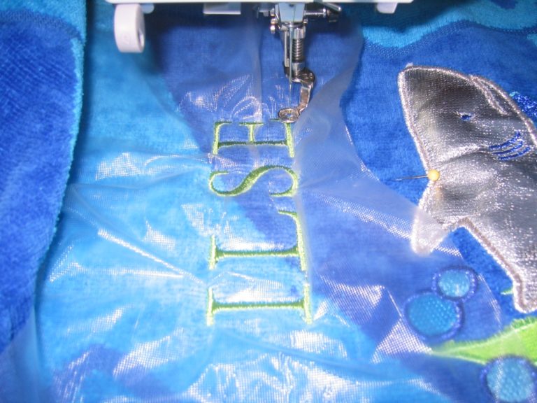 embroidering a name on a towel