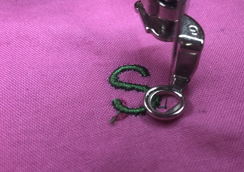 letter stitched out on fabric using embroidery machine