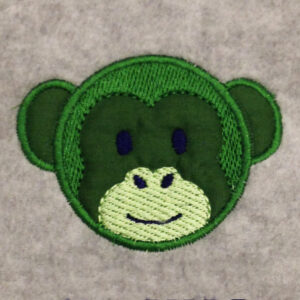 Adorable monkey face machine appliqué design with embroidered details