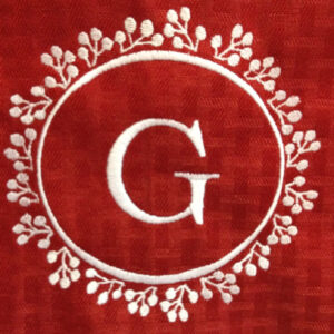 Single initial monogram wreath with decorative branches. Lovely wreath monogram with single initial in two sizes