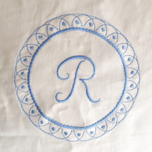 Single initial monogram embroidery design surrounded with decorative wreath.   Delicate monogram embroidery design in two sizes