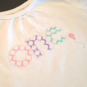Adorable one-year-old appliqué and embroidery design with balloon in 7 styles and sizes