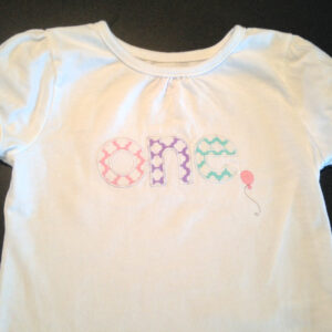 Adorable one-year-old appliqué and embroidery design with balloon in 7 styles and sizes