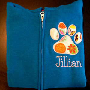 Eight different versions of a paw print applique and embroidery design: satin stitch, triple stitch and filled embroidery design.