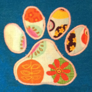 Eight different versions of a paw print applique and embroidery design: satin stitch, triple stitch and filled embroidery design.