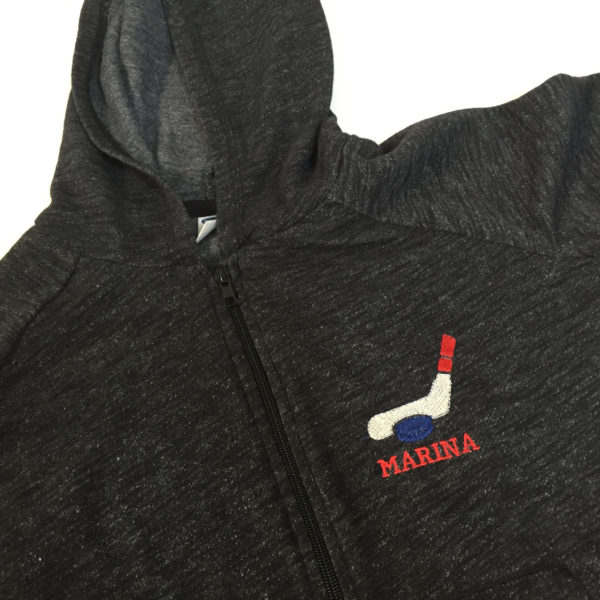 hockey stick and puck embroidered on a sweatshirt