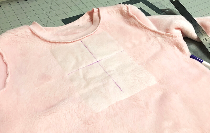 positioning fusible poly mesh on inside of sweatshirt