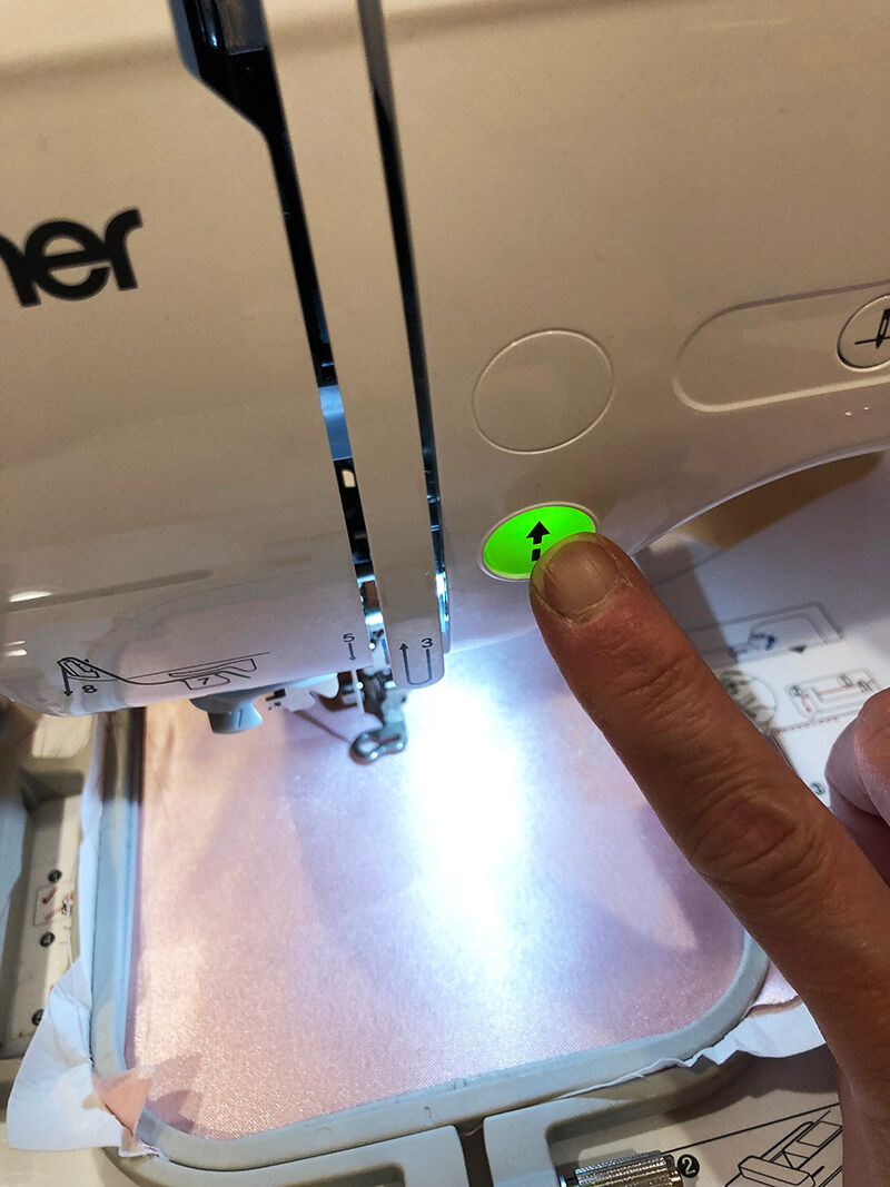 button to start embroidering on embroidery machine