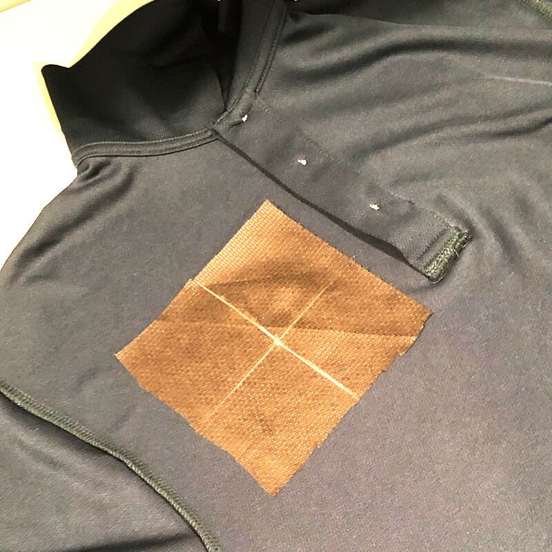 crosshairs on the fusible poly mesh on the inside of the polo