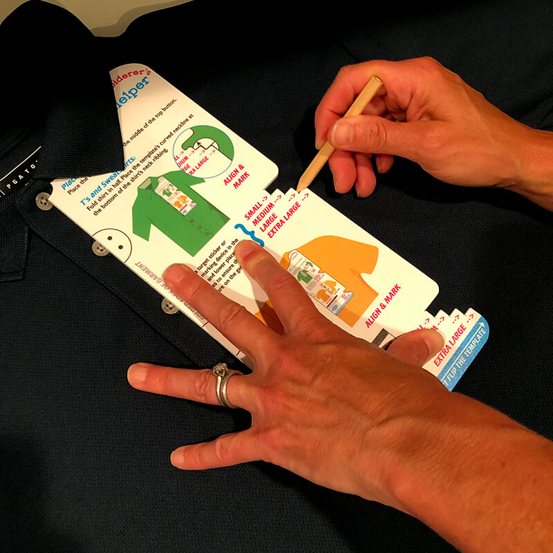 Using the Embroiderer's helper to place the embroidery on the polo