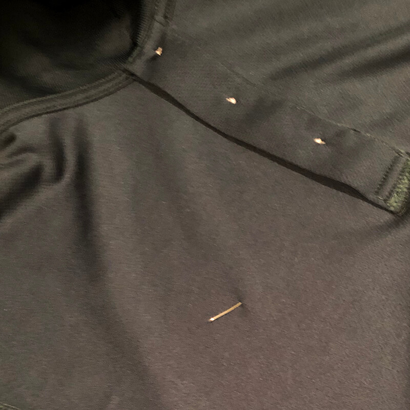 pin marking the location of the logo on the polo