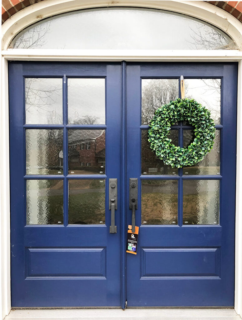 Front door with one wreath down