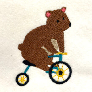 Bear on tricycle embroidery design